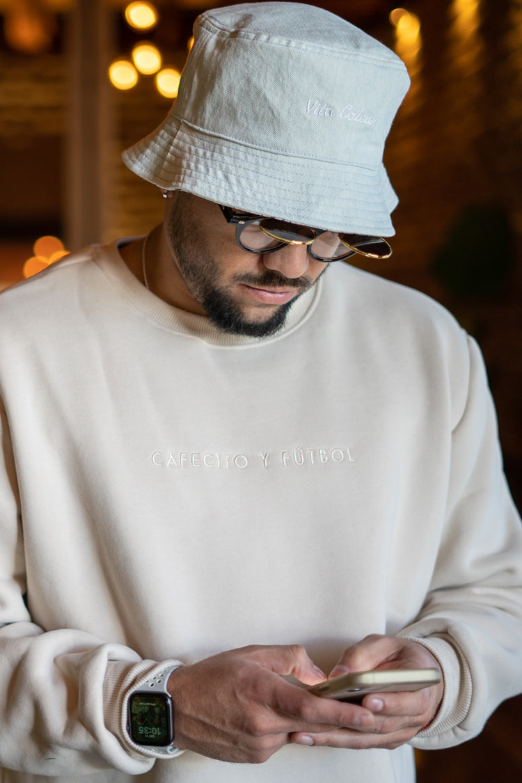 jesus gonzalez wearing our cafecito y futbol crewneck and reversible bucket hat