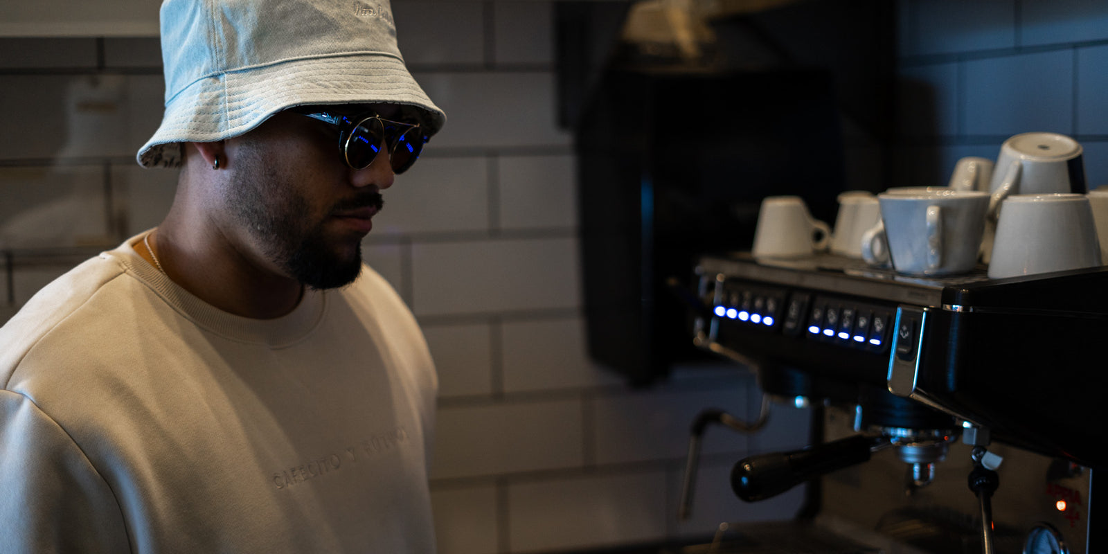 jesus gonzalez wearing our cafecito y futbol crewneck and reversible bucket hat